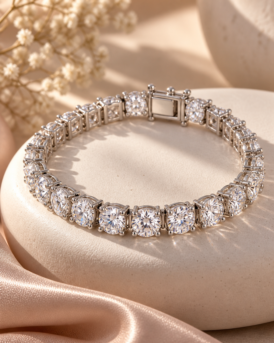 Bold 6 mm silver tennis bracelet with brilliant clear stones on an ivory curve